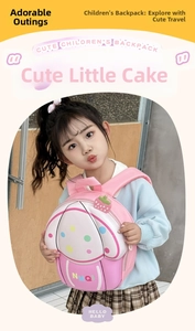 Detail showing the strawberry topping and 3D cupcake shape of the pink children's backpack