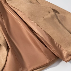 Close-up of camel faux suede jacket showing lapel detail and smooth satin lining