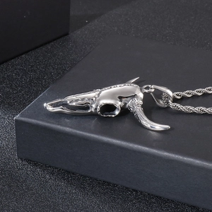 Detailed macro shot of a punk style silver ox skull pendant on a twisted rope chain