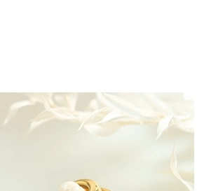 Detailed macro view of a gold plated ring with a natural white baroque pearl