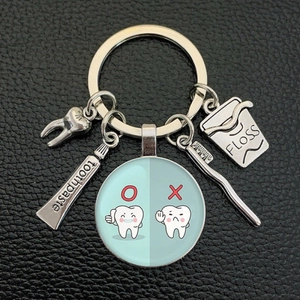 Creative dental care keychain with toothbrush toothpaste and cartoon tooth charms