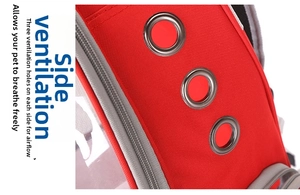 Detailed close-up of side ventilation holes and metal zipper on the red pet carrier backpack