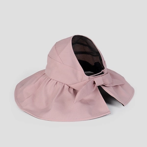 Macro detail of breathable black mesh lining and pink bow on visor sun hat