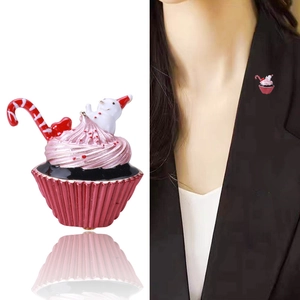 Detail of Christmas snowman cupcake brooch with pink enamel finish and red candy cane