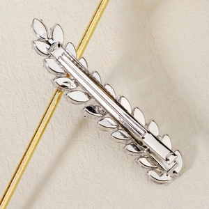 Detailed back view of a silver leaf hair clip showing the durable spring fastener mechanism