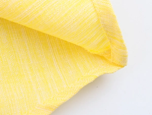 Detailed macro shot of yellow woven fabric texture on a rural style floral dress