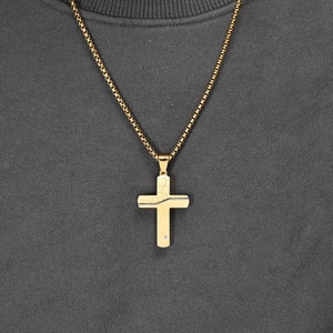 Men's titanium steel gold cross necklace featuring unique earth crack texture on a grey tee