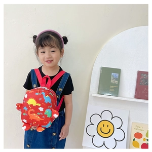 Close-up of red kids dinosaur backpack featuring vibrant cartoon prints and durable 3D details