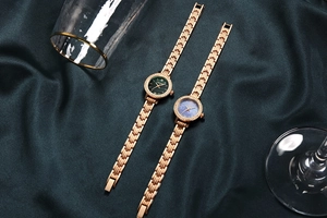 Detail of luxury women's watches with rhinestone bezels on green silk background