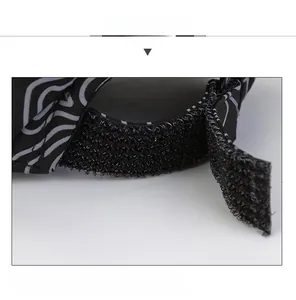 Detail view of adjustable velcro strap on black wool newsboy hat for men's custom fit