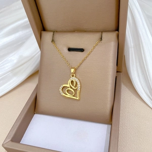 Luxurious gold heart necklace with love script and crystal inlay on jewelry box