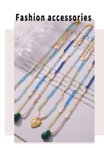 Detail of beaded necklaces with malachite heart pendants and pearls on a magazine