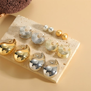 Collection of geometric shell design earrings in gold and silver plating with pearls