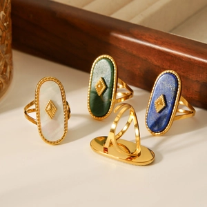 Detail of 18K gold plated stainless steel rings with shell and turquoise stone inlay