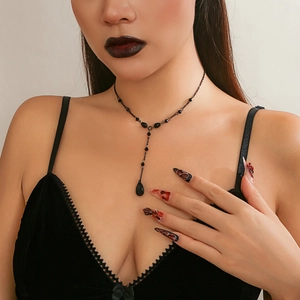 Close-up of gothic black beaded Y-necklace with blood-drop crystal pendant on model