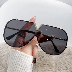 Oversized V-shape metal frame sunglasses with one-piece dark lens and gold accents