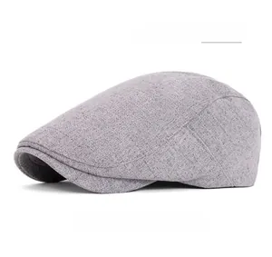 Detailed view of gray flat cap showing fabric texture and functional back button buckle