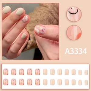 Short sweet graffiti press-on nails set with orange patterns and smiley faces