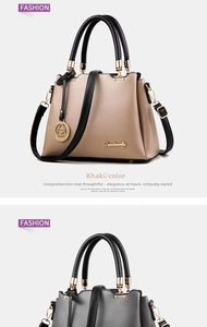 Detail of grey and khaki PU leather handbags with golden hardware and black handles