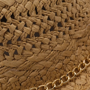 Detailed macro view of khaki hand-woven straw hat texture with thick gold metal chain