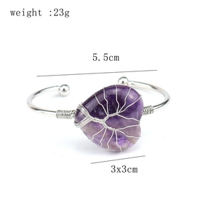 Macro detail of handmade silver wire wrapped heart amethyst stone tree of life bangle