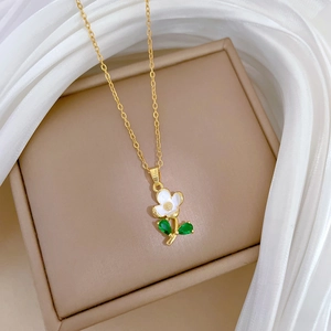 Detail of floral necklace with white petals and green leaves on a luxury gift box