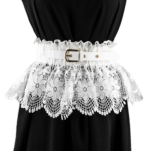 Detail of white floral lace corset belt with a gold buckle on black clothing backdrop
