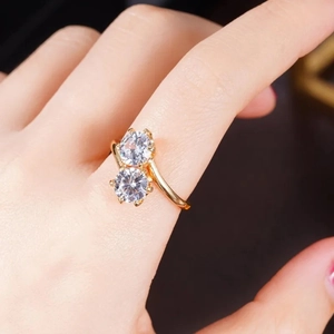 Macro shot of Toi et Moi gold-plated ring featuring two brilliant-cut round cubic zirconias