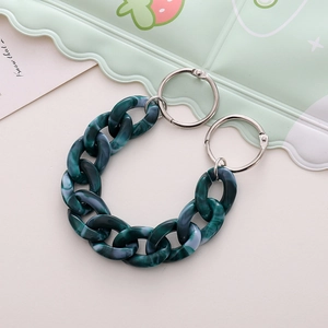 Close-up of dark green marble acrylic chain link with silver metal rings for clog shoes