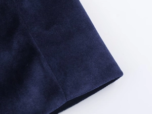 Detailed macro shot of deep blue velvet fabric texture and professional stitching finish
