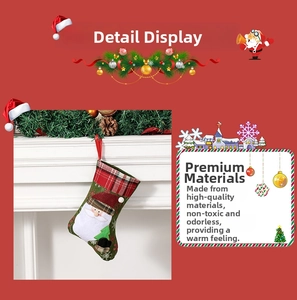 Close-up of green felt Christmas stocking with Santa Claus and red plaid cuff on fireplace
