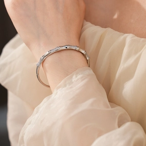 Close-up of silver bamboo joint bangle with cubic zirconia on a female wrist