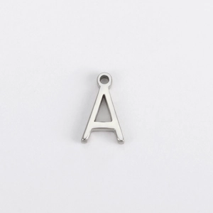Macro shot of silver stainless steel letter A pendant with polished finish and jump ring