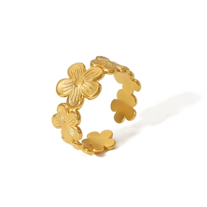 Macro detail of 18k gold plated stainless steel floral ring with open adjustable band