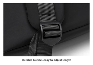 Detail of adjustable strap with durable plastic buckle on a black nylon backpack