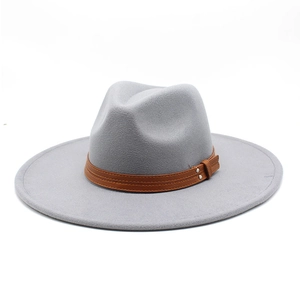 Close-up of gray wool felt jazz fedora with brown leather band and metal rivets detail