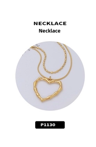 Detail of layered gold-plated heart necklace featuring textured bamboo pattern and chains