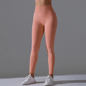 Detail of coral peach high waist yoga leggings with ribbed tummy control and peach lift effect