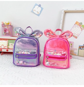 Detail of pink and purple laser PU kids backpacks with glitter sequins and bow decoration