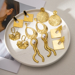 Collection of vintage 18K gold earrings featuring geometric shapes and pearl details