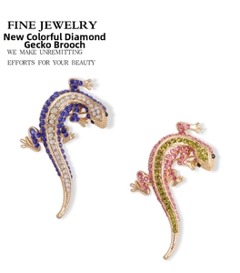 Detail of crystal lizard brooches with colorful rhinestones in blue and pink finishes