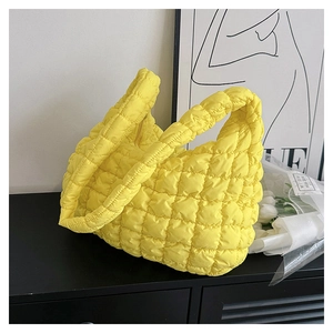 Quilted puffer cloud shoulder bag in bright yellow with a soft pleated texture design