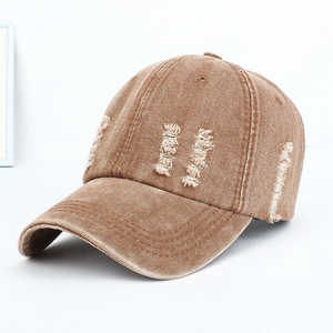 Detailed view showing the distressed texture on a vintage washed denim baseball cap