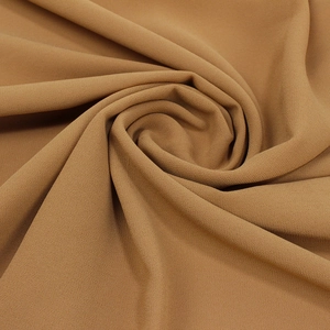 Detail shot of camel 75D pearl chiffon fabric showing smooth fine sand texture and drape