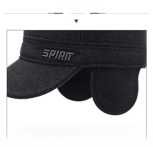 Close-up of thick grey tweed fabric and Spirit embroidery on winter earflap cap