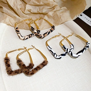 Detail of square leopard and zebra print earrings with soft faux fur texture and gold hooks