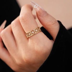 Close-up of gold plated flower ring with sparkling zircon stones on a model's hand