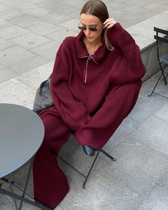 Macro detail of wine red oversized half-zip knit sweater and wide-leg knit pants
