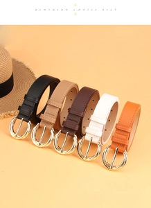 Detailed view of fashionable faux leather belts in five colors with golden round buckles