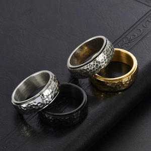 Titanium steel spinner rings with honeycomb hammered texture in gold, black and silver